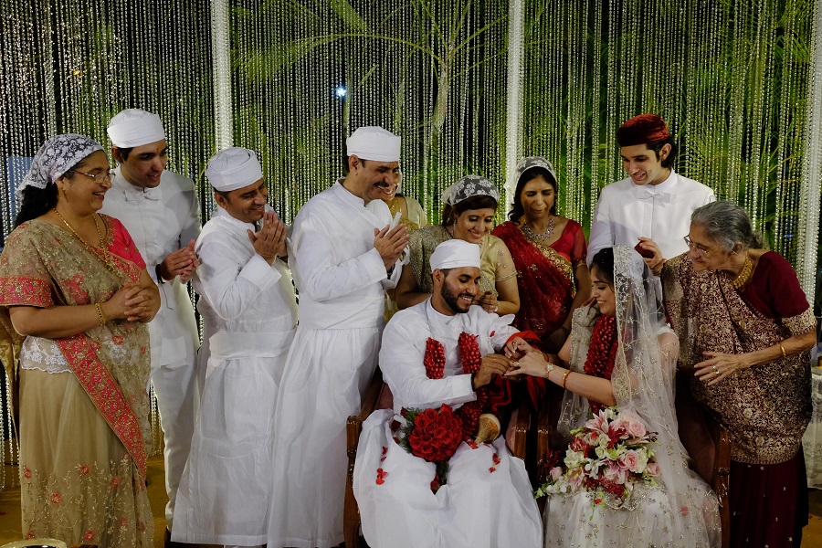 A couple exchanged wedding rings to mark an end to wedding rituals. Blooming hues of red and white set the tone for a Parsi wedding, far away from the flashy and OTT wedding spirit of a grand Indian wedding affair. Steeped in Zoroastrian culture, the simplicity of a Parsi wedding is almost mesmerising