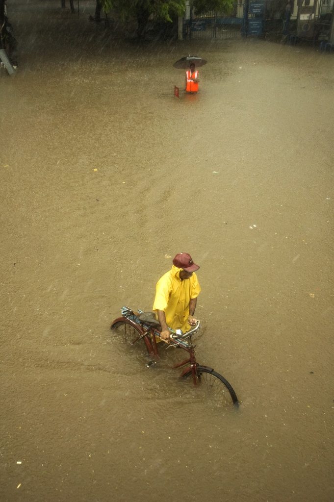 Flooding and waterlogging, that annual feature of monsoons. People, in general, continue living their lives adapting to the hardships that accompany the rains. Parel; Mumbai. 2006